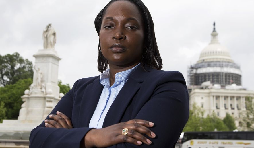 In this photo taken May 13, 2016, Mary Tobin, wearing her West Point class ring, poses for picture in Washington, Friday, May 13, 2016. Self-expression is hardly a part of life for cadets at the United States Military Academy at West Point.Tobin, who has mentored other black women cadets since graduating in 2003, said the experience is one rarely discussed publicly. (AP Photo/Manuel Balce Ceneta)