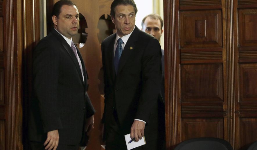 FILE - In this April 26, 2013, file photo, New York Gov. Andrew Cuomo, right, and Joseph Percoco, executive deputy secretary, stand at a news conference in Albany, N.Y. A federal investigation of two former top aides to Andrew Cuomo, including Percoco, is threatening to taint the Democratic governor’s signature economic development efforts even as it adds to Albany’s reputation for insider dealing. (AP Photo/Mike Groll, File)
