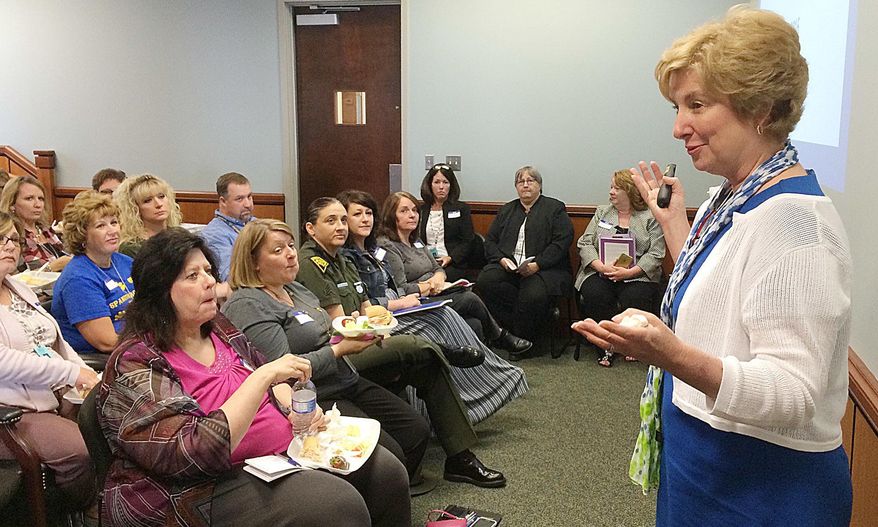 ADVANCE FOR MONDAY MAY 16 AND THEREAFTER This Wednesday May 11, 2016 photo shows Andrea Darr, director of the West Virginia Center for Children's Justice speaking at the Mercer County Family Court to school officials and law enforcement agencies about the program, "Handle With Care" in Princeton W.Va. A new program being organized in Mercer County could give teachers notice when one of their students needs to be handled with care. (Greg Jordan/Bluefield Daily Telegraph via AP)