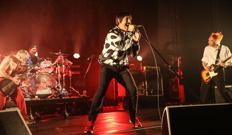 FILE - In this Feb. 5, 2016, file photo, Flea, from left, Chad Smith, Anthony Kiedis and Josh Klinghoffer of the Red Hot Chili Peppers perform at The Theatre at Ace Hotel in Los Angeles. The Red Hot Chili Peppers were forced to cancel an appearance at a California radio station’s annual concert after lead singer Kiedis was hospitalized. Flea told the crowd Saturday, May 14, in Orange County that the Chili Peppers would be unable to perform. (Photo by Rich Fury/Invision/AP, File)