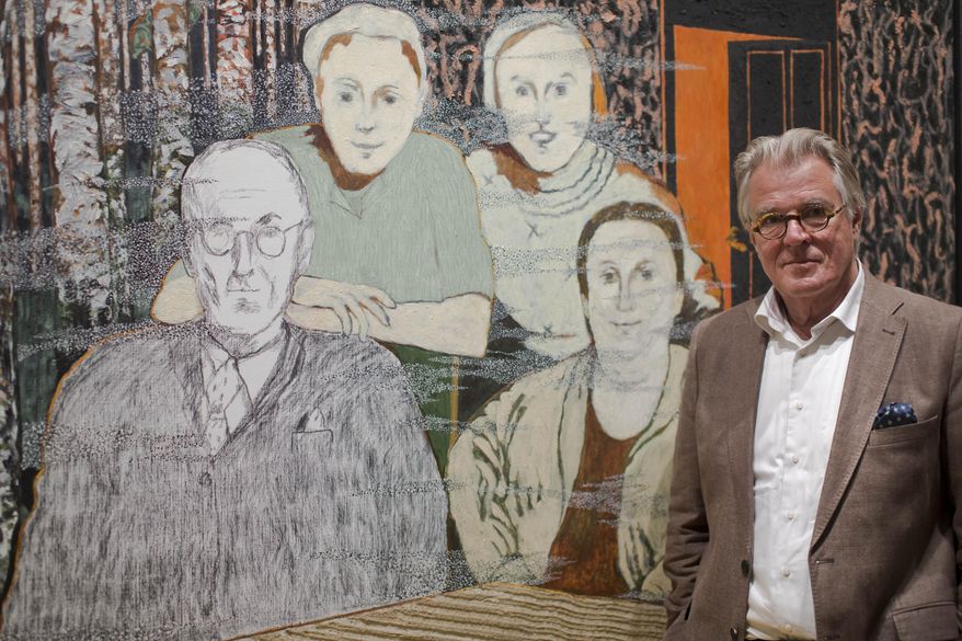 Dutch actor and artist Jeroen Krabbe poses in front of his painting which tells the story of his grandfather Abraham Reiss, left, who was murdered in the Sobibor Nazi German extermination camp, during a press preview at the National Holocaust Museum in Amsterdam, Netherlands, Thursday, May 12, 2016. More than 70 years after tens of thousands of Dutch Jews were deported and murdered by the Nazis, the Netherlands is finally getting a national Holocaust museum. (AP Photo/Peter Dejong)