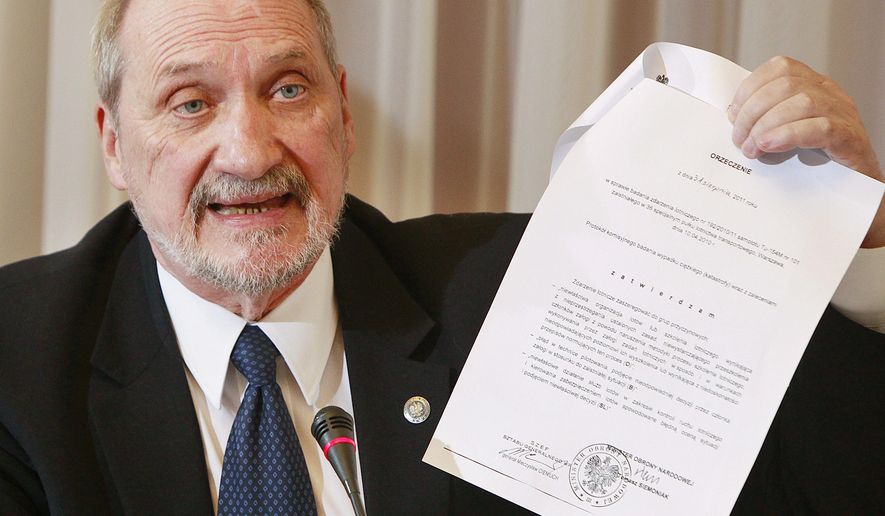FILE - In this March 30, 2016 file photo Poland's Defense Minister Antoni Macierewicz shows a document during a session of a special parliamentary commission. in Warsaw . Several former Polish defense ministers are calling for Macierewicz's dismissal, arguing that he is undermining the image of Poland's military within NATO and in Polish society itself. (AP Photo/Czarek Sokolowski)