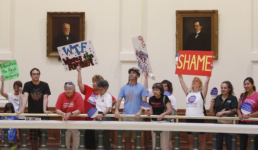 File - In this June 6, 2011, file photo, protesters against cuts in funding for Texas public schools rally in the rotunda in the state capitol, in Austin, Texas. Now that it’s clear Texas’ complicated school finance system is here to stay, cash-strapped districts around the state must find a way to move forward, whether that’s pressuring lawmakers for more money or finding a taste for raising property taxes. (AP Photo/Eric Gay, File)