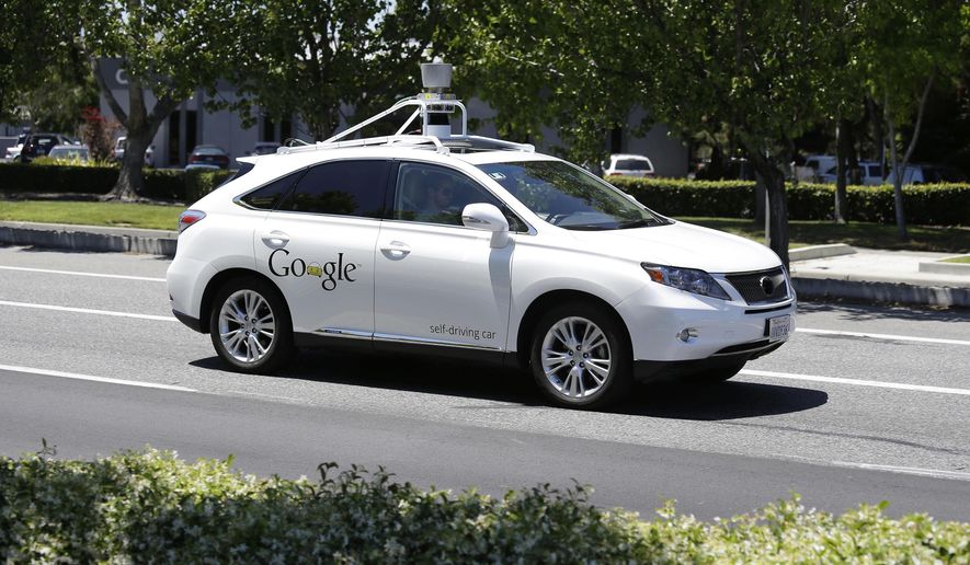 FILE - In this May 13, 2014 file photo, a Google self-driving car goes on a test drive near the Computer History Museum in Mountain View, Calif. Self-driving cars are expected to usher in a new era of mobility, safety and convenience. The problem, say transportation researchers, is that people will use them too much. (AP Photo/Eric Risberg, File)