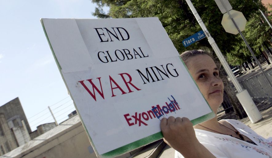 Valley Reed of Dallas was one of two demonstrators outside of the Exxon Mobil shareholders meeting in Dallas, Wednesday, May 27, 2009. (AP Photo/Mike Stone) ** FILE **