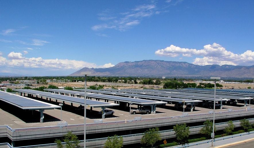 This undated image provided by the City of Albuquerque shows the rows of solar panels installed on the top level of the parking structure at the city's international airport in Albuquerque, N.M. Two Albuquerque city councilors have introduced a resolution that calls for 25 percent of the electricity used at city facilities to come from solar by 2025. (City of Albuquerque via AP)