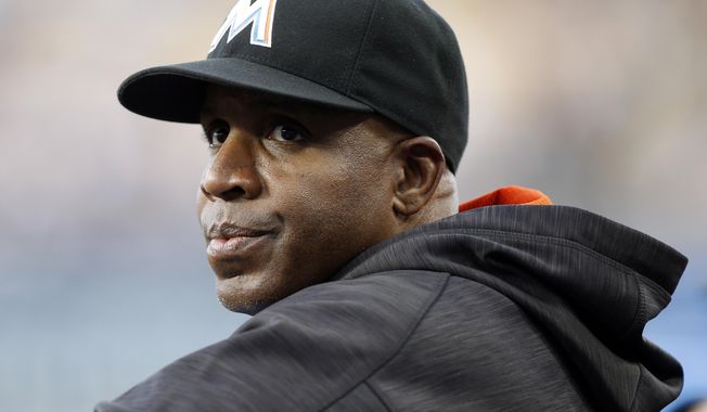 In this April 27, 2016, file photo, Miami Marlins hitting coach Barry Bonds stands in the dugout during the first inning of a baseball game against the Los Angeles Dodgers in Los Angeles. (AP Photo/Alex Gallardo, File)