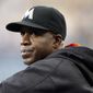 In this April 27, 2016, file photo, Miami Marlins hitting coach Barry Bonds stands in the dugout during the first inning of a baseball game against the Los Angeles Dodgers in Los Angeles. (AP Photo/Alex Gallardo, File)