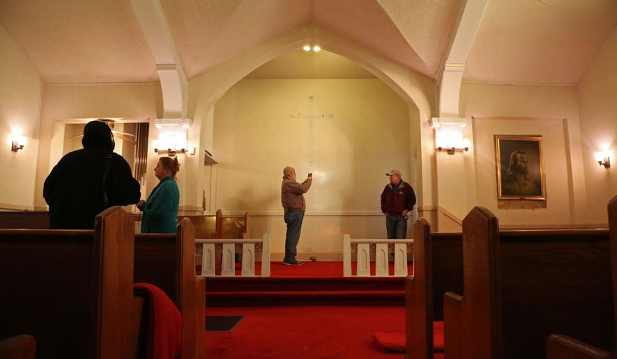 In this Jan. 14, 2015 photo, a group of people tour the former Burns United Methodist Church in Des Moines. Time is running out for preservationists who want to save a brick chapel in Des Moines that once was home to one of the oldest black congregations in Iowa. (Kelsey Kremer/The Des Moines Register via AP) MAGS OUT, TV OUT, NO SALES, MANDATORY CREDIT