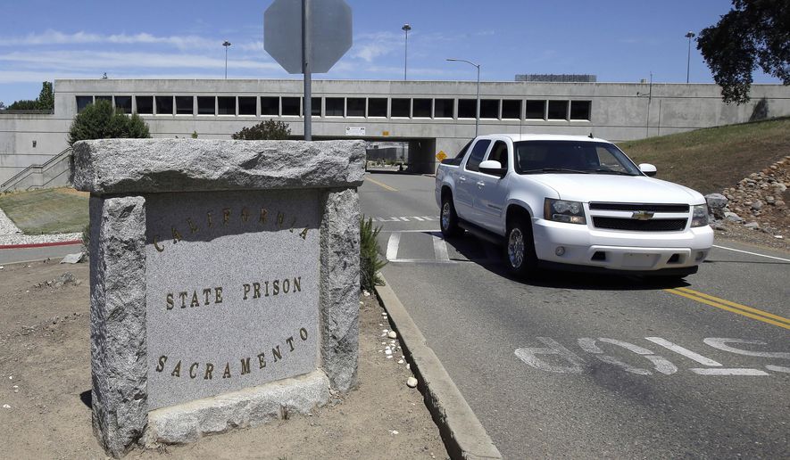 A vehicle drives by the main entrance to California State Prison, Sacramento, Monday, May 16, 2016, in Folsom, Calif. Authorities say one inmate was shot by a guard and another inmate was repeatedly stabbed during a fight among at least multiple inmates at the maximum security Northern California prison. (AP Photo/Rich Pedroncelli)