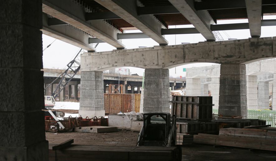 FILE - In this Dec. 2, 2014, file photo, construction continues on Interstate 35E in St. Paul, Minn. Gov. Mark Dayton says he is presenting a middle ground on a transportation funding plan but that it is up to Republicans to meet him halfway. (AP Photo/Jim Mone ,File)