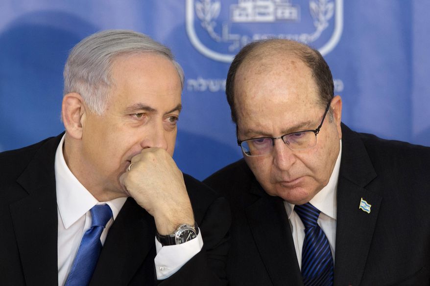 FILE - In this Feb. 16, 2015 file photo, Israeli Prime Minister Benjamin Netanyahu, left, speaks with Israel&#39;s Defense Minister Moshe Yaalon during a ceremony for new Israeli Chief of Staff Gadi Eizenkot at the Prime Minister&#39;s office in Jerusalem. A public spat between Prime Minister Benjamin Netanyahu and his defense minister has exposed a simmering rift between Israel’s security establishment and its hard-line government, pitting the Israeli leader in a risky showdown. (AP Photo/Sebastian Scheiner, File)
