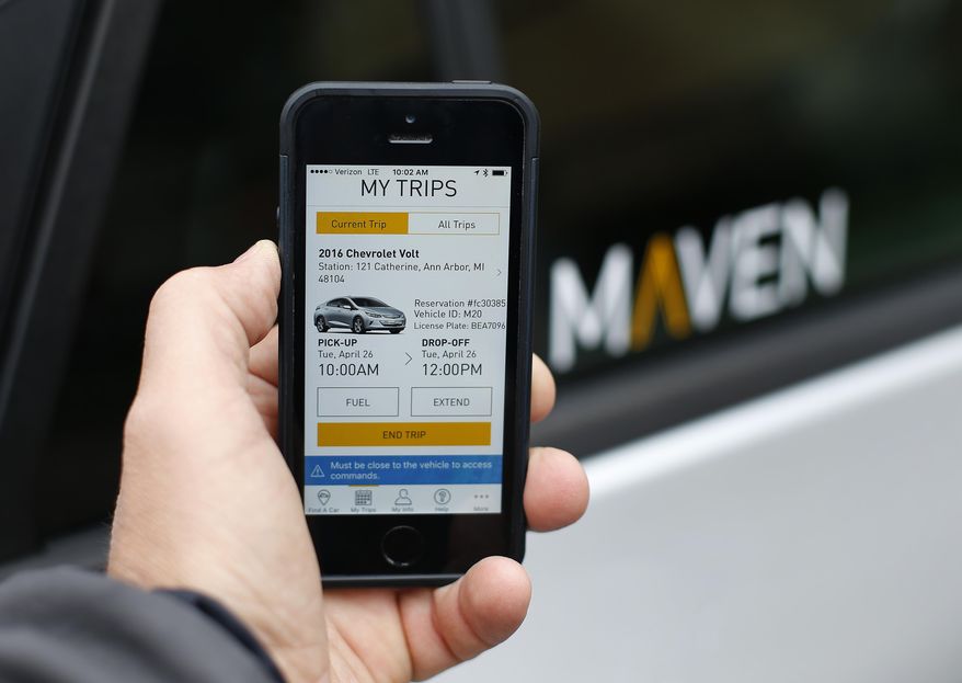 In this Wednesday, April 27, 2016, photo, a smartphone displaying the Maven app, a General Motors car-sharing service, is shown, in Ann Arbor, Mich. Automakers are reinventing themselves as "mobility" companies that can accommodate all the different ways people get around. Already this year, General Motors Co. has announced a long-term alliance with ride-hailing company Lyft and started Maven. (AP Photo/Paul Sancya)