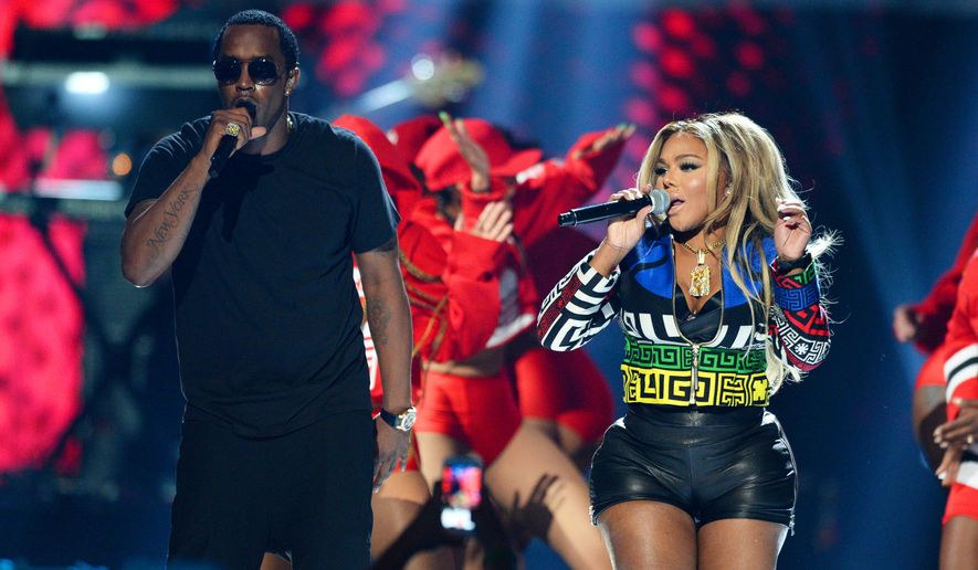 FILE - In this Sept. 19, 2015, file photo, Puff Daddy, left, performs with Lil Kim at the 2015 iHeartRadio Music Festival in Las Vegas. Puff Daddy is reuniting with Lil Kim, Mase, Faith Evans and more for a Bad Boy Records reunion tour kicking off Aug. 25, 2016, in Columbus, Ohio. (Photo by Al Powers/Powers Imagery/Invision/AP, File)
