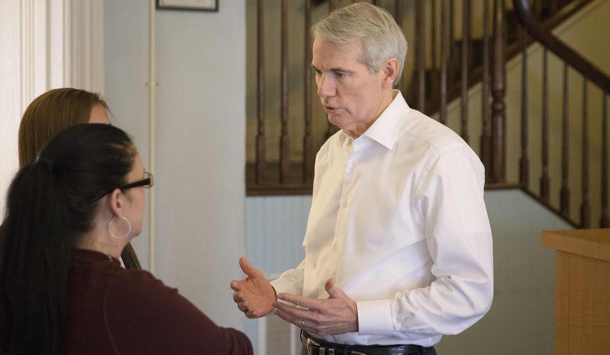 U.S. Sen. Rob Portman, R-Ohio, right, speaks with treatment residents as tours the First Step Home, a women's drug addiction treatment facility, Monday, May 16, 2016, in Cincinnati. The facility permits children up to the age of 12 to remain with their mothers during their treatment stay. (AP Photo/John Minchillo)