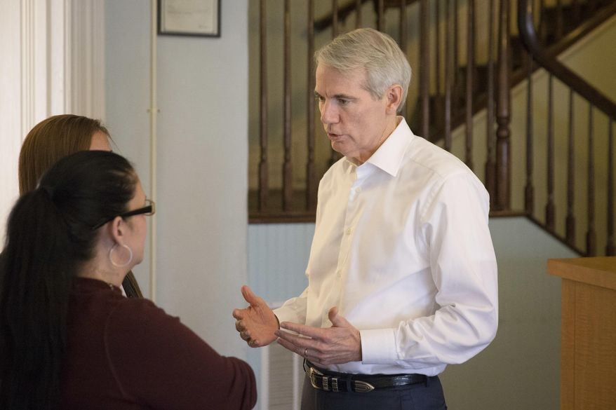 U.S. Sen. Rob Portman, R-Ohio, right, speaks with treatment residents as tours the First Step Home, a women's drug addiction treatment facility, Monday, May 16, 2016, in Cincinnati. The facility permits children up to the age of 12 to remain with their mothers during their treatment stay. (AP Photo/John Minchillo)