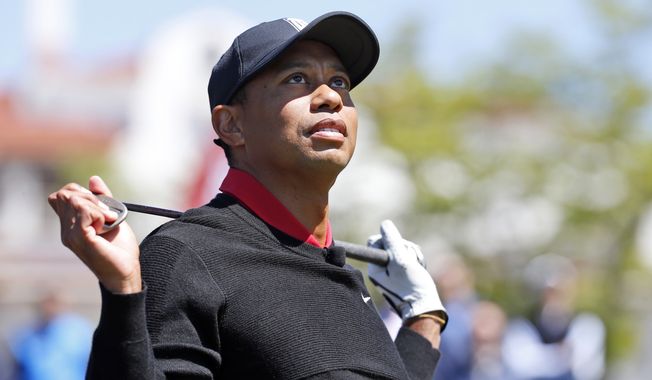 Tiger Woods watches a hit before hitting three ceremonial golf balls during a Quicken Loans National tournament media availability on the 10th tee at Congressional Country Club, Monday, May 16, 2016 in Bethesda, Md. (AP Photo/Alex Brandon)