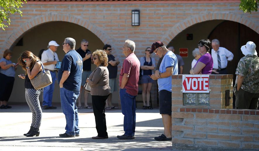 FILE - In this March 22, 2016 file photo, voters wait in line to cast their ballot in Arizona's presidential primary election in Gilbert, Ariz. Voters across Arizona head to the polls Tuesday, May 17, 2016, to decide the fate of education funding and pension overhaul measures at a special election. The election will also test whether efforts Maricopa County took to avoid a repeat of the long lines seen during the March presidential primary worked. (AP Photo/Matt York, File)