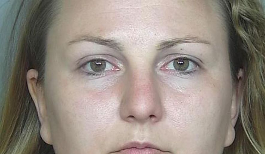 This booking photo provided by the Weld County, Colo., Sheriff's Department on Tuesday, May 17, 2016 shows Rachel Einspahr. Investigators say that Einspahr, who was baby sitting two children at the time, robbed a bank in Severance, Colo., on Friday, May 13, 2016, to get cash to pay back money that she stole from two northern Colorado businesses where she worked. (Weld County, Colo., Sheriff's Department via AP)