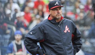 FILe - In this Oct. 4, 2015, file photo, Atlanta Braves manager Fredi Gonzalez (33) waits for a review of a call during the fourth inning of the second baseball game of a doubleheader against the St. Louis Cardinals, in Atlanta. The Atlanta Braves have fired manager Fredi Gonzalez, who couldn’t survive the worst record in the majors.  Braves general manager John Coppolella confirmed the firing of Gonzalez, in his sixth season, Tuesday, May 17, 2016. (AP Photo/John Amis, File)