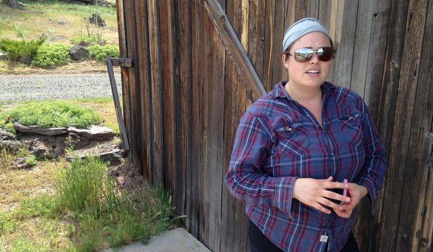 FILE - In this Thursday, May 12, 2016 file photo, Lindsey Pate stands next to an old building in Redmond, Ore., on property she and her husband bought less than a year ago to grow marijuana. Two Oregon counties might rescind bans on marijuana production and sales - which are allowed by state law - during Oregon's primary election Tuesday, May 17, 2016. The ballot measures are taking place in Klamath and Grant counties. (AP Photo/Andrew Selsky, File)