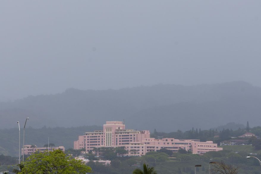 FILE - This May 2, 2014 file photo shows the Tripler Army Medical Center, where Sgt. Michael Walker has been assigned since 2013, shrouded in rain clouds in Honolulu. The Army medic charged with conspiring with his lover to kill his wife in Hawaii will be court-martialed for child pornography and prostitution charges that surfaced while investigating the killing. Walker's general court-martial is set for June 20 and June 21 at Wheeler Army Airfield on Oahu, said Jim Guzior, spokesman for Tripler Army Medical Center. A pretrial hearing is scheduled for next week. (AP Photo/Marco Garcia, File)