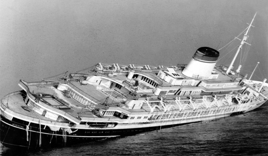 FILE - In this July 26, 1956 file photo, the Italian luxury liner Andrea Doria keels far over to starboard before sinking 225 feet to the bottom of the Atlantic 45 miles off Nantucket Island, Mass. Nearly six decades after the Andrea Doria slammed into another ocean liner, killing 46 people, explorers are preparing to do what 16 others have lost their lives attempting: get a fresh glimpse of the wreckage on the sea floor. Everett, Washington-based OceanGate will use a five-person submarine in June 2016 to get high-definition video and 3-D sonar images of the shipwreck. (AP Photo/John Rooney, File)