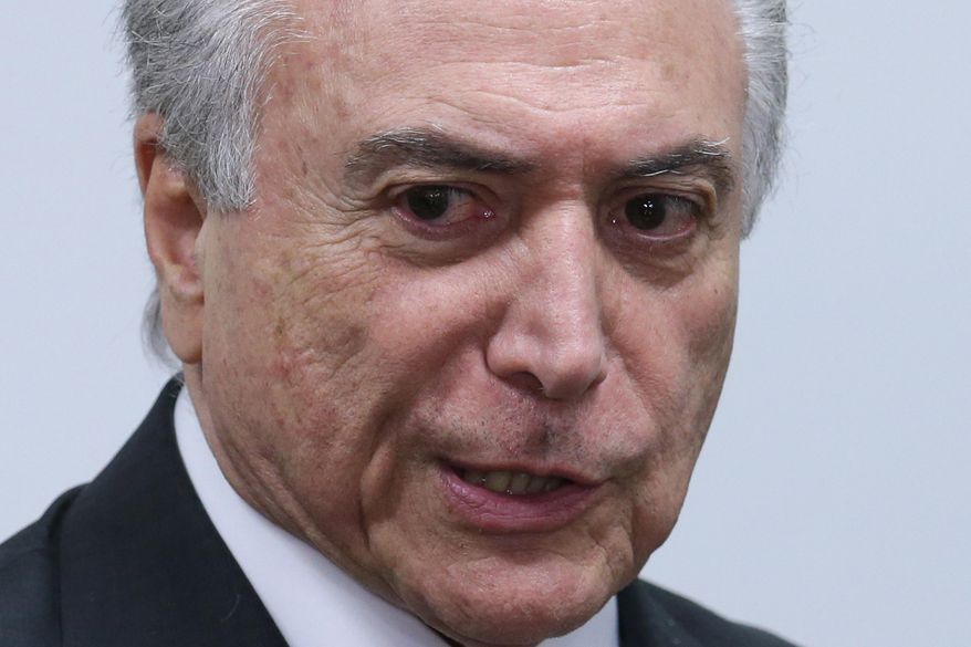Brazil's acting President Michel Temer attends a meeting of ministers and military commanders on the preparations for the Rio 2016 Olympic Games, at the Planalto Presidential Palace, in Brasilia, Brazil, Monday, May 16, 2016. Temer assumed the presidency last week after President Dilma Rousseff was impeached and suspended for allegedly employing accounting tricks to hide gaping deficits in the federal budget. (AP Photo/Eraldo Peres)