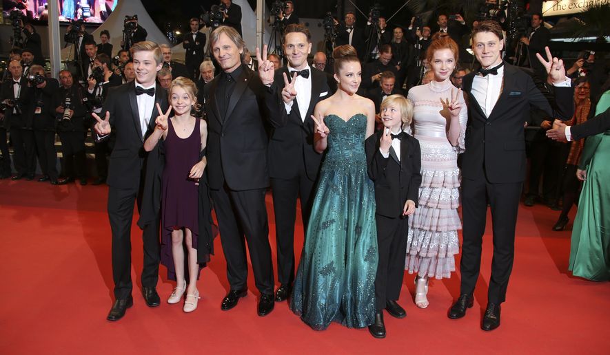Actors Nicholas Hamilton, Shree Crooks, Viggo Mortensen, director Matt Ross, Samantha Isler, Charlie Shotwell, Annalise Basso, from left, pose for photographers upon arrival at the screening of the film Personal Shopper at the 69th international film festival, Cannes, southern France, Tuesday, May 17, 2016. (AP Photo/Joel Ryan)