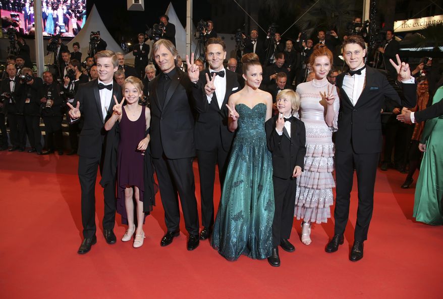 Actors Nicholas Hamilton, Shree Crooks, Viggo Mortensen, director Matt Ross, Samantha Isler, Charlie Shotwell, Annalise Basso, from left, pose for photographers upon arrival at the screening of the film Personal Shopper at the 69th international film festival, Cannes, southern France, Tuesday, May 17, 2016. (AP Photo/Joel Ryan)