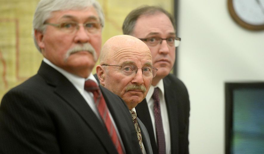 Joseph Campbell, center, flanked by his council, Greg Jackson, left, and Chad Wright, look on just before District Court Judge DeeAnn Cooney ruled on Campbell's change of plea and sentencing, Wednesday morning, May 18, 2016, at the Lewis and Clark County Courthouse in Helena, Mont. Campbell, who pleaded no contest to negligent homicide in the October 2013 shooting death of his neighbor, was given a 20-year suspended prison sentence in an agreement with prosecutors. (Rion Sanders/The Great Falls Tribune via AP) NO SALES; MANDATORY CREDIT