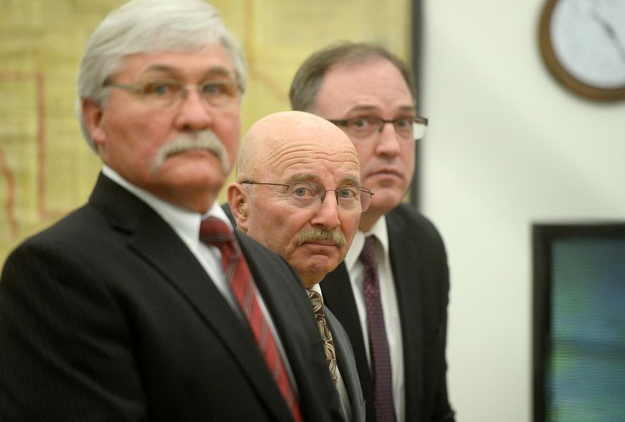 Joseph Campbell, center, flanked by his council, Greg Jackson, left, and Chad Wright, look on just before District Court Judge DeeAnn Cooney ruled on Campbell's change of plea and sentencing, Wednesday morning, May 18, 2016, at the Lewis and Clark County Courthouse in Helena, Mont. Campbell, who pleaded no contest to negligent homicide in the October 2013 shooting death of his neighbor, was given a 20-year suspended prison sentence in an agreement with prosecutors. (Rion Sanders/The Great Falls Tribune via AP) NO SALES; MANDATORY CREDIT