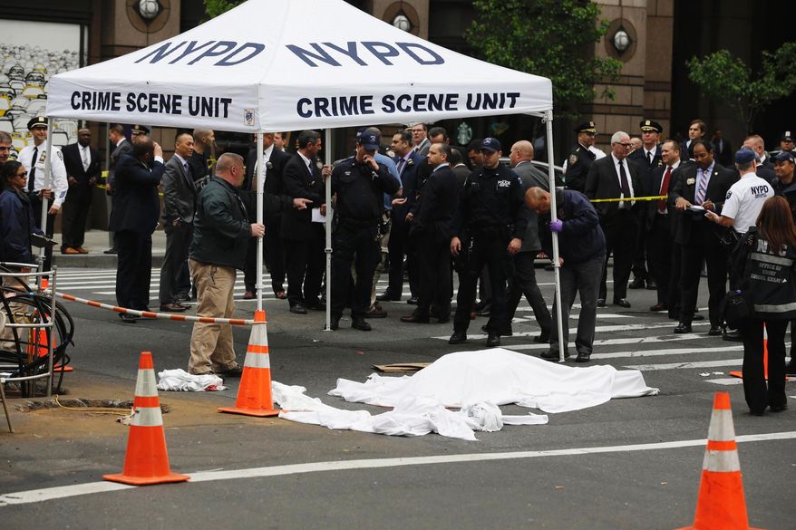 Police work at the scene following a fatal shooting in New York on Wednesday, May 18, 2016. The incident occurred near a few of Broadway's big theaters. (AP Photo/Seth Wenig)