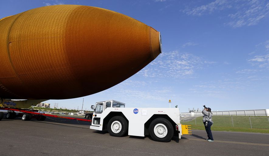FILE - In this Sunday, April 10, 2016 file photo, external Tank, ET- 94, NASA's only remaining space shuttle external tank, is transported by trailer to a dock at the NASA Michoud Assembly Facility in New Orleans. The tank is embarking on a journey, via the Gulf of Mexico and the Panama Canal, to the California Science Center in Los Angeles, as part of the Space Shuttle Endeavour display. The tank ET-94 is scheduled to arrive Wednesday, May 18, 2016, in Los Angeles and then head later in the week to the science center. (AP Photo/Gerald Herbert)