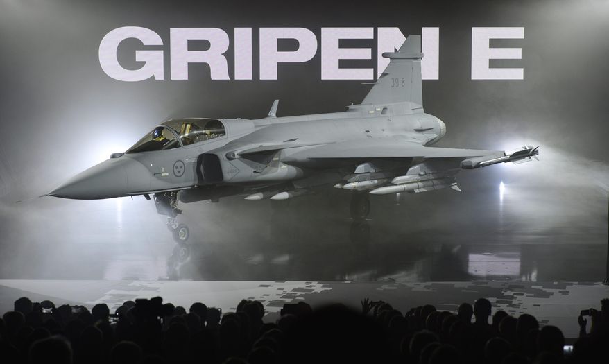 The new E version of the Swedish JAS 39 Gripen multi role fighter being rolled out at SAAB in Linkoping, Sweden, Wednesday, May 18, 2016. Swedish aircraft maker Saab has unveiled the latest version of its Gripen fighter jet. The E fighter is slightly bigger than previous versions, has a stronger engine and updated radar systems. It has been in development for about 10 years. The first test flight is expected later this year. (Anders Wiklund/TT via AP) SWEDEN OUT
