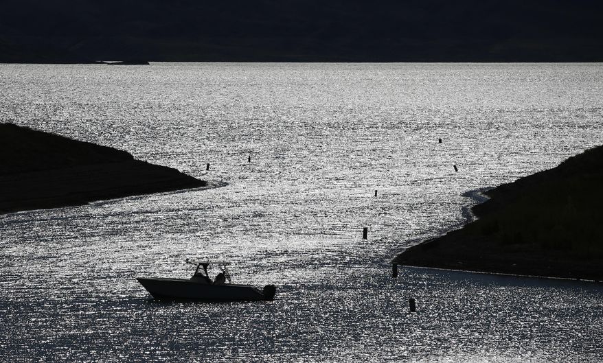 A boater drifts toward a boat ramp in an area that was once under water at the Lake Mead National Recreation Area, Thursday, May 19, 2016, near Las Vegas. Lake Mead's surface was at its lowest level Wednesday since the reservoir was created. (AP Photo/John Locher)
