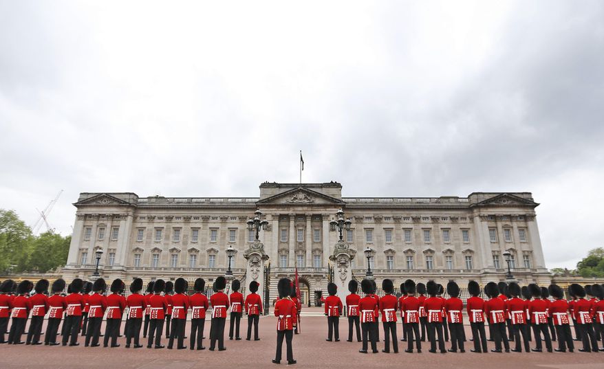 Guardsmen parade out Buckingham Palace before Britain's Queen Elizabeth II travels in a carriage to the Houses of Parliament in London, Wednesday, May 18, 2016. The Queen will give a speech to parliament above the government's programme for the upcoming parliamentary year .(AP Photo/Frank Augstein)