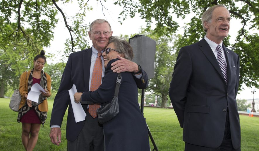 Sen. Barbara Boxer, D-Calif., embraces Senate Environment and Public Works Committee Chairman Sen. James Inhofe, R-Okla., on Capitol Hill in Washington, Thursday, May 19, 2016, during a news conference to discuss bipartisan legislation to improve the federal regulation of chemicals and toxic substances. Sen. Tom Carper, D-Del. is at right. (AP Photo/J. Scott Applewhite)
