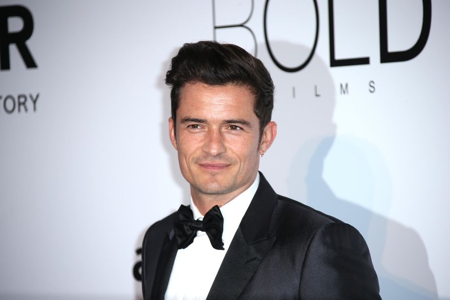 Actor Orlando Bloom poses for photographers upon arrival at the amfAR Cinema Against AIDS benefit at the Hotel du Cap-Eden-Roc, during the 69th Cannes international film festival, Cap d'Antibes, southern France, Thursday, May 19, 2016. (AP Photo/Joel Ryan)