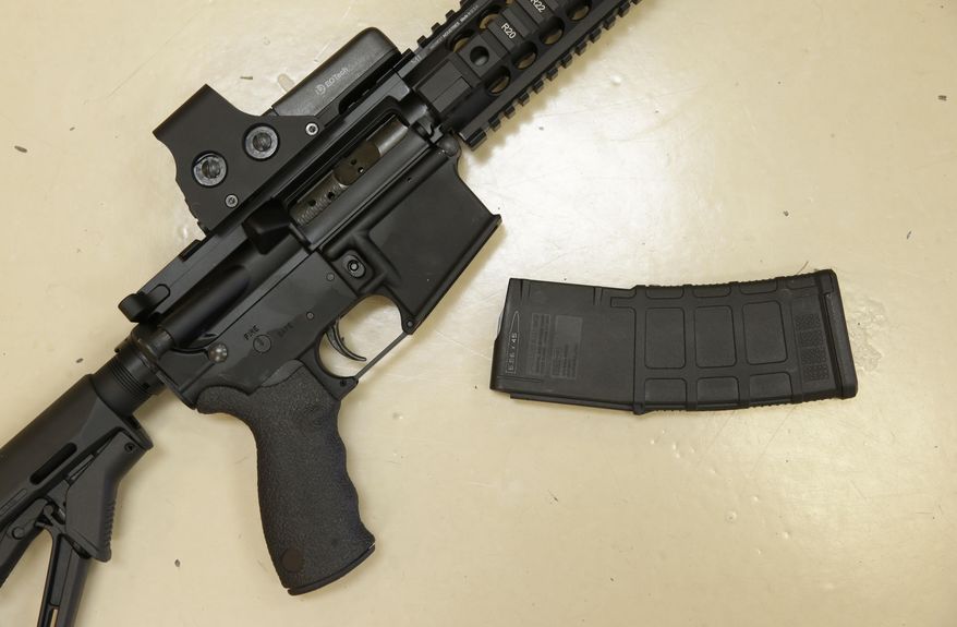 FILE - In this Oct. 3, 2013, file photo, a custom-made semi-automatic hunting rifle with a high-capacity detachable magazine is displayed at TDS Guns in Rocklin, Calif. Democrats in the California Senate plan another attempt to outlaw the sale of assault rifles with easily detachable ammunition magazines known as bullet buttons. The measure is among a wide-ranging slate of gun control bills scheduled for Senate votes on Thursday, May 19, 2016, as Democratic leaders rush to head off a ballot measure advocated by Lt. Gov. Gavin Newsom. (AP Photo/Rich Pedroncelli,File)