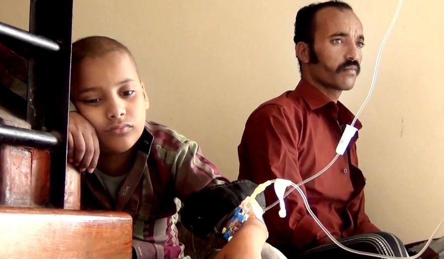 This image made from video taken on May 7, 2016 shows, Feras Ali Hassan, a 10-year-old who is being diagnosed with leukemia, left, and his father Ali Hassan, waiting in front of a clinic in Taiz. Yemen's civil war has wreaked massive destruction and created a humanitarian disaster in what was already the Arab's world's poorest country. Taiz, one of the worst battlegrounds, has seen another level of misery: The city of around 400,000 is home to Yemen's largest cancer hospital, the Amal Hospital, and the war has doomed hundreds of its patients to death because they are unable to get treatment. Hassan, was diagnosed with leukemia at the age of 6, had seen improvement over two and a half years of treatment at Amal. But for months, his father couldn't get him to treatment because the family lived in a frontline district, Wadi Hanish. (AP Video via AP)