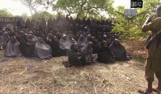 RETRANSMISSION TO REMOVE NAME OF POTENTIAL RAPE VICTIM - FILE - This May 12, 2014, file image taken from video posted by Nigeria&#39;s Boko Haram terrorist network purports to show the missing girls abducted from a boarding school in the northeastern town of Chibok. Soldiers have found one of the kidnapped girls, her uncle said Wednesday, May 18, 2016 describing her as pregnant and traumatized but otherwise fine. (Militant Video via AP, File)