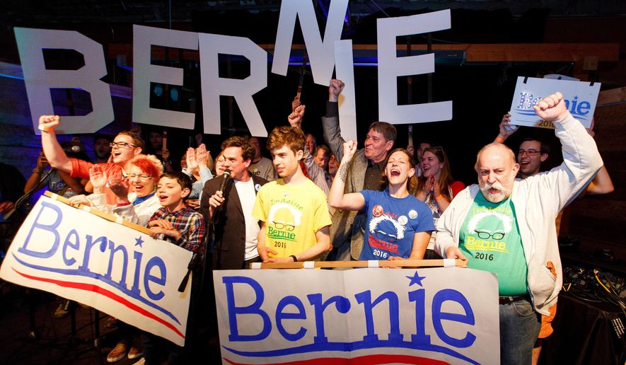 Bernie Sanders supporters react to poll results during the Oregon primary election during a rally in Eugene, Ore. Tuesday May 17, 2016. After Bernie Sanders won Oregon's Democratic primary this week, two superdelegates announced they'll back the Vermont senator while one declared support for Hillary Clinton. The developments come amid increased distaste with a system viewed as undemocratic, even among some of the superdelegates themselves. (Ryan Kang/The Register-Guard via AP)