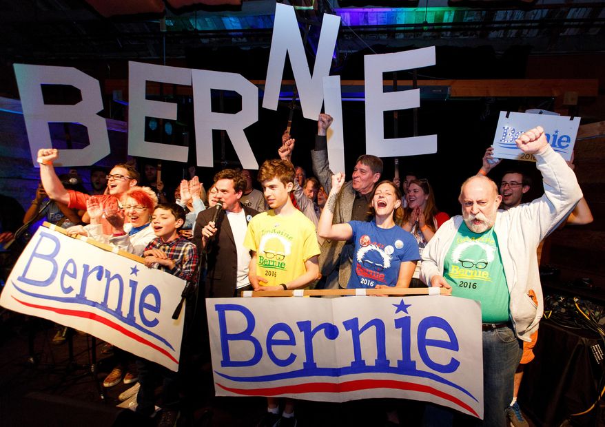 Bernie Sanders supporters react to poll results during the Oregon primary election during a rally in Eugene, Ore. Tuesday May 17, 2016. After Bernie Sanders won Oregon's Democratic primary this week, two superdelegates announced they'll back the Vermont senator while one declared support for Hillary Clinton. The developments come amid increased distaste with a system viewed as undemocratic, even among some of the superdelegates themselves. (Ryan Kang/The Register-Guard via AP)