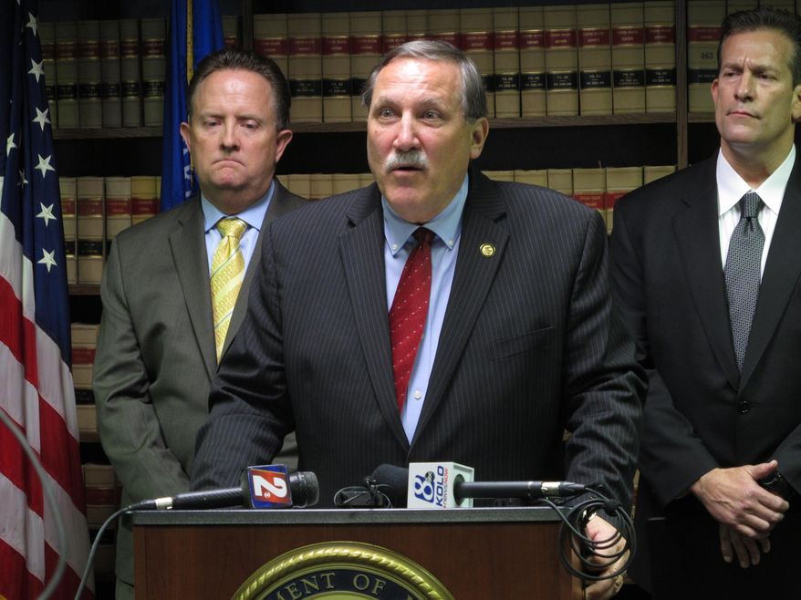 FILE - In this Wednesday, May 11, 2016 file photo, Daniel Bogden, U.S. attorney for Nevada, describes efforts to combat illegal prescription drug trafficking as Daniel Neill, left, assistant special agent for the Drug Enforcement Administration, and FBI assistant special agent Patrick Brodsky, right, look on at a news conference in Reno, Nev. A federal investigation into a prescription drug-trafficking ring in Reno is the most extensive in the state to date. Dr. Robert Rand, the doctor at the center of the Reno case, is scheduled to enter a plea in federal court on Thursday afternoon, May 19, 2016. (AP Photo/Scott Sonner, File)