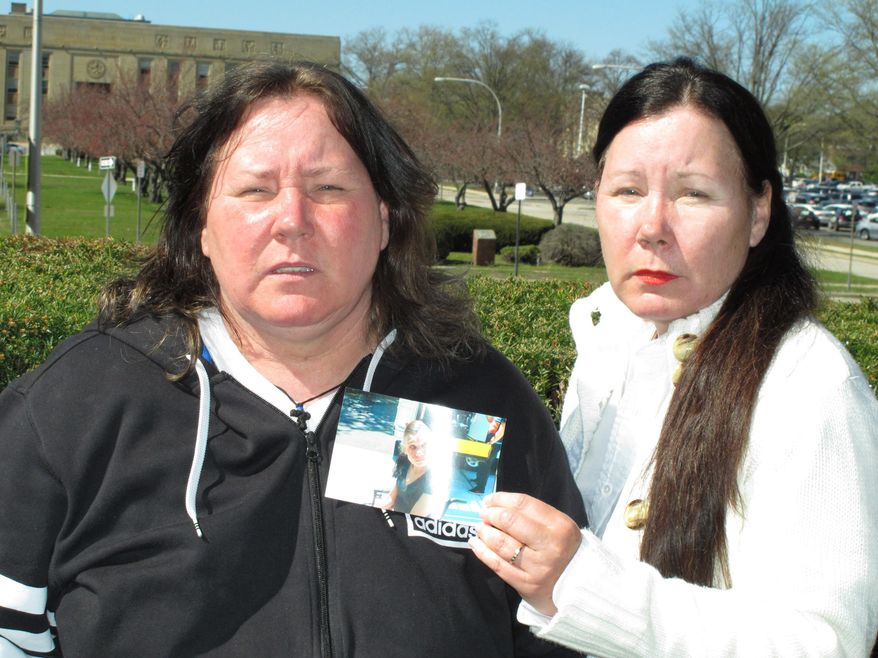In this Wednesday, April 20, 2016 photo, sisters Patricia Ann Jirak, left, and Catherine Jirak Monetti, pose holding a photograph of their sister, Carolyn, in Mineola, N.Y. Carolyn Jirak is one of the disabled people who have died in state care since 2013 in Suffolk County with abuse or neglect allegations, yet none has resulted in criminal charges. The sisters contend Carolyn's death followed weeks of mistreatment. (AP Photo/Frank Eltman)