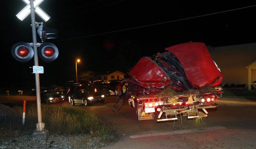 The remains of a pickup truck that collided with Amtrak's "City of New Orleans" passenger train in Flora, Miss., is removed Wednesday night, May 18, 2016. The Madison County Sheriff's Office confirmed the evening accident, but would not confirm any deaths, saying the Flora Police Department is investigating. (AP Photo/Rogelio V. Solis)