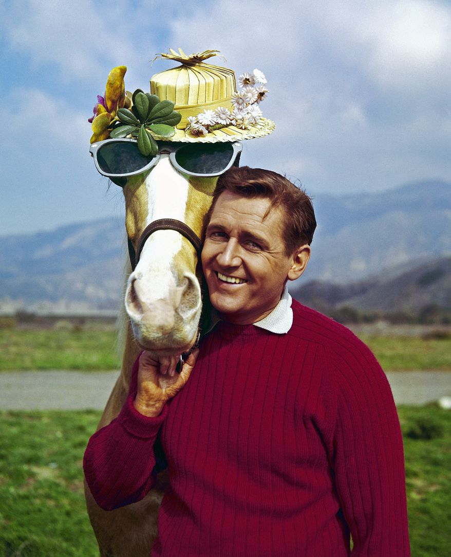 In this March 22, 1962, file photo, Mister Ed, equine star of the television series of the same name, poses with his TV co-star Alan Young on a beach in Malibu, Calif. Young, who played straight man to the talking horse in the 1960s sitcom, has died. He was 96. (AP Photo, File)