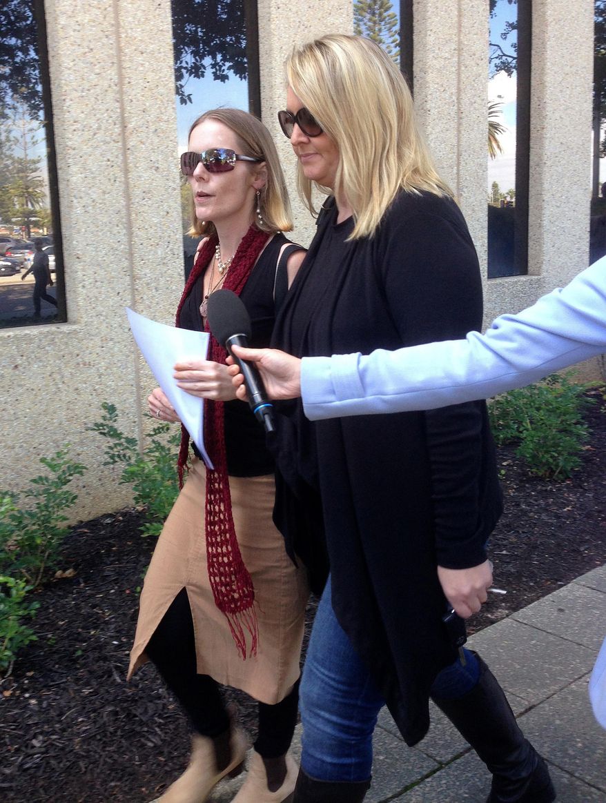 Angela Kiszko, left, walks with an unidentified woman after leaving a court house in Perth, Australia, on Friday, May 20, 2016, after a judge ruled in favor of a couple who refused to allow their 6-year-old son to undergo radiotherapy for a malignant brain tumor. Princess Margaret Hospital in Perth had applied for a Family Court order forcing Kiszko's son, Oshin, to undergo radiotherapy for a rare cancer known as medulloblastoma that was diagnosed in December. (Angie Raphael/AAP Image via AP) NO ARCHIVING, AUSTRALIA OUT, NEW ZEALAND OUT, PAPUA NEW GUINEA OUT, SOUTH PACIFIC OUT