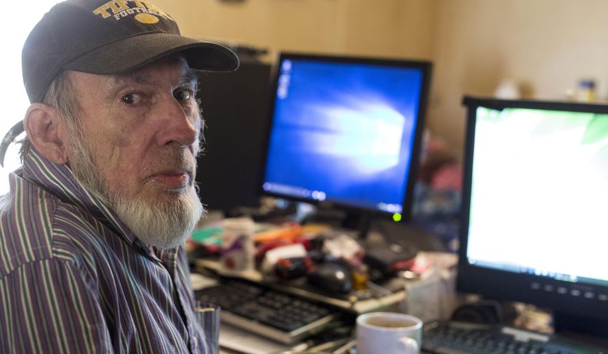 In this Tuesday, April 12, 2016 photo, James Fritz poses for a photo as he works on computers in the bedroom of his home in Elkhart, Ind. He has donated more than 400 computers to those who can’t afford them otherwise. He also helps fix and update computers for a fee. (Amanda Wilkinson/The Elkhart Truth via AP) MANDATORY CREDIT